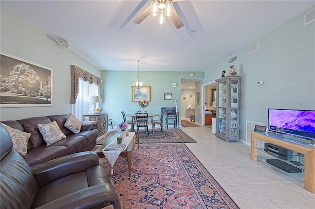 living room with ceiling fan and light tile patterned floors