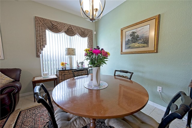 dining area with light tile patterned floors and an inviting chandelier