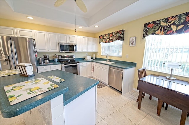 kitchen featuring white cabinets, a healthy amount of sunlight, and appliances with stainless steel finishes