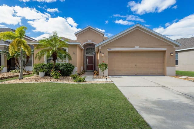 ranch-style home with a front yard and a garage