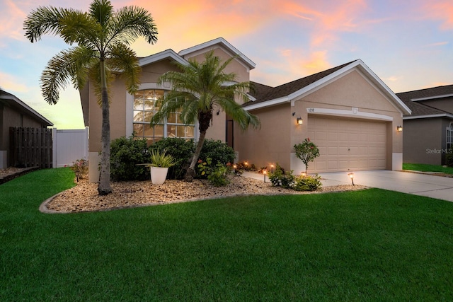 ranch-style home with a lawn and a garage