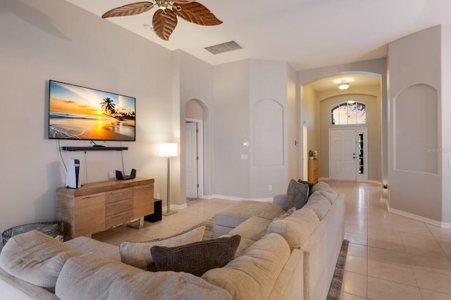 tiled living room with ceiling fan