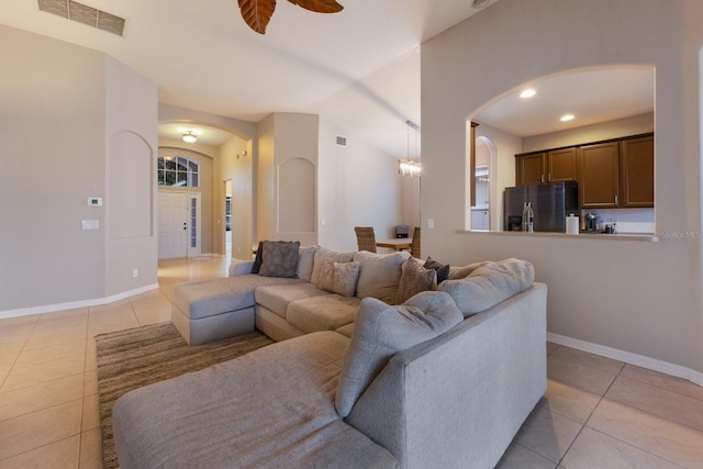 tiled living room featuring ceiling fan