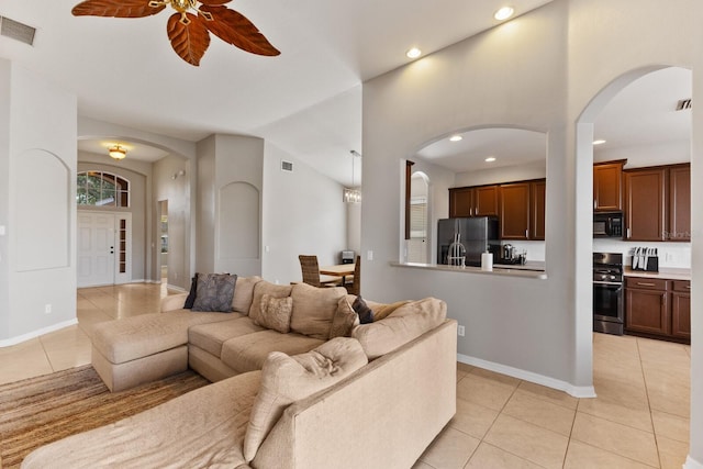 tiled living room featuring ceiling fan