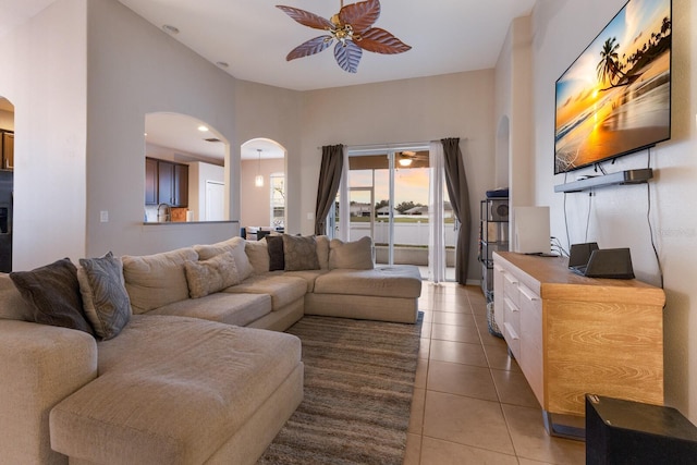 tiled living room with ceiling fan