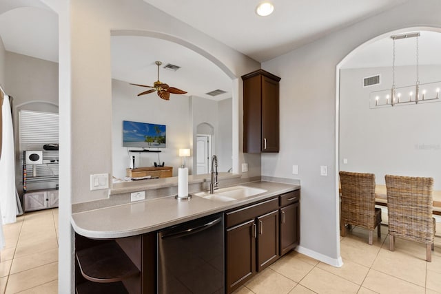 kitchen featuring ceiling fan with notable chandelier, sink, stainless steel dishwasher, light tile patterned floors, and dark brown cabinets