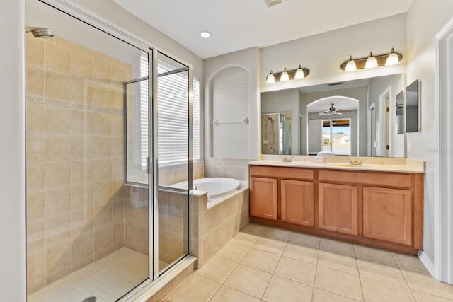 bathroom featuring plus walk in shower, vanity, tile patterned flooring, and ceiling fan