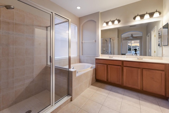 bathroom featuring tile patterned flooring, shower with separate bathtub, vanity, and ceiling fan