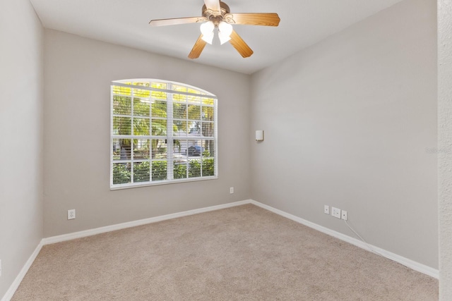 empty room featuring light carpet and ceiling fan