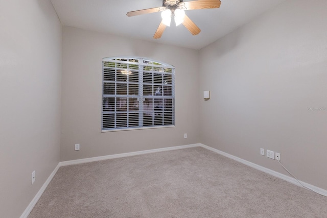 carpeted empty room featuring ceiling fan