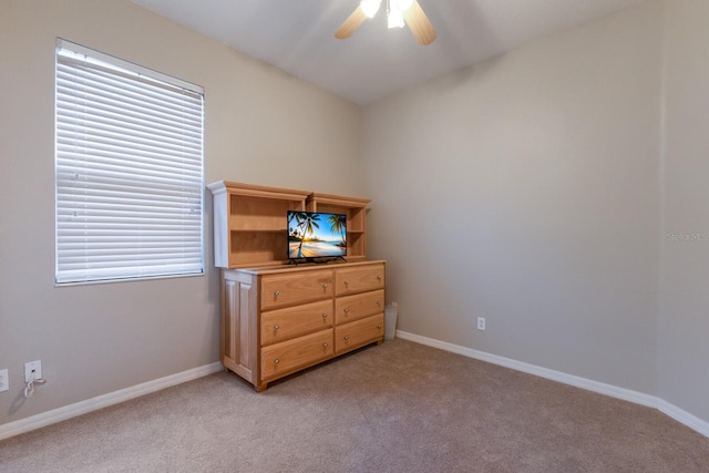 carpeted bedroom featuring multiple windows and ceiling fan