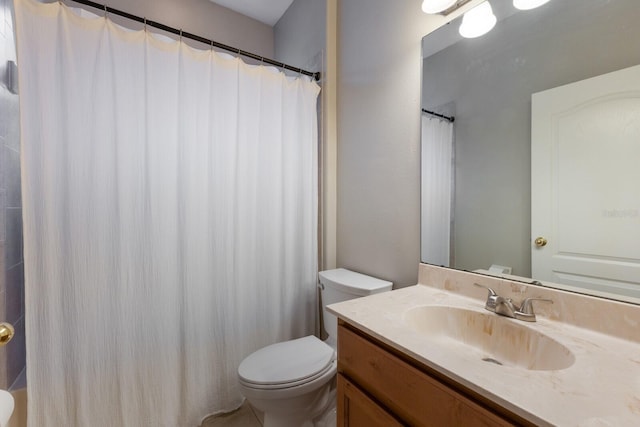 bathroom featuring curtained shower, vanity, and toilet