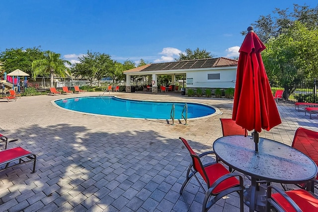 view of swimming pool with a patio