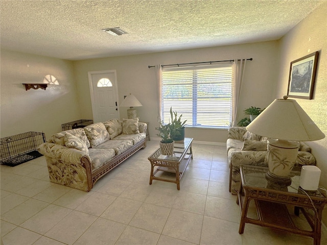 tiled living room featuring a textured ceiling