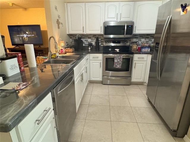 4121 Durant St, Port Charlotte, FL 33948 - kitchen featuring appliances with stainless steel finishes, a peninsula, decorative backsplash, and white cabinets