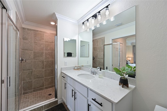 bathroom featuring a shower with shower door, ornamental molding, and vanity