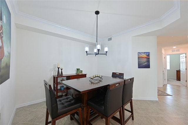 tiled dining area featuring a chandelier and ornamental molding