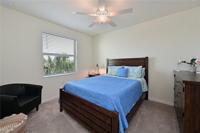 bedroom featuring light colored carpet and ceiling fan