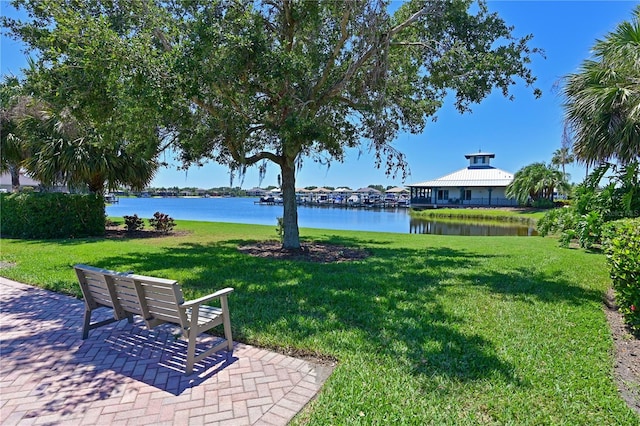 view of home's community featuring a water view and a lawn