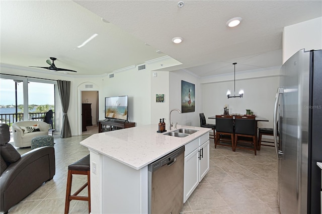 kitchen featuring white cabinetry, sink, stainless steel appliances, an island with sink, and ceiling fan with notable chandelier