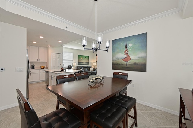 dining room with light tile patterned flooring, sink, crown molding, and an inviting chandelier