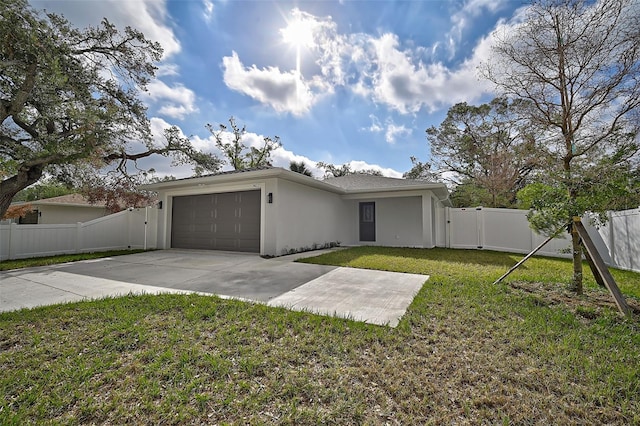 view of front of property featuring a garage and a front lawn