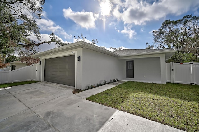 single story home featuring a garage and a front yard