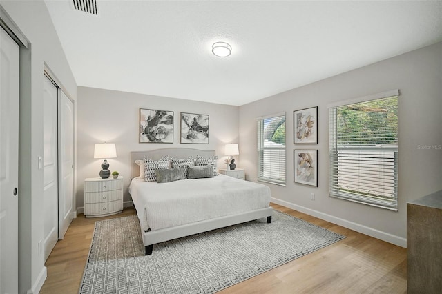 bedroom with hardwood / wood-style floors and a closet