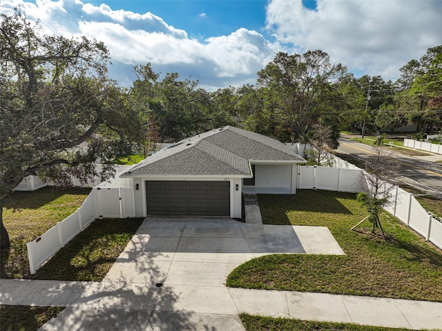 view of front of home featuring a front yard and a garage