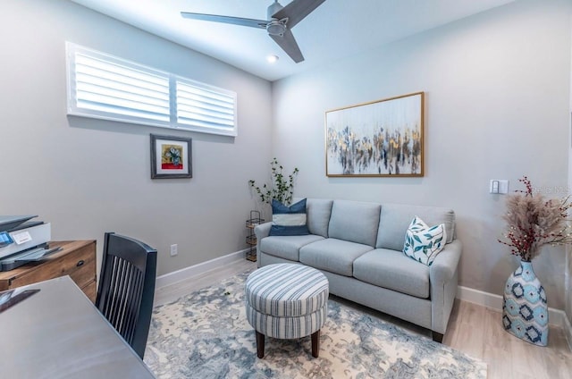 living room featuring ceiling fan and light hardwood / wood-style floors