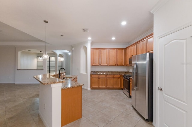 13627 American Prairie Pl, Lakewood Ranch, FL 34211 - kitchen with arched walkways, stainless steel appliances, light tile patterned flooring, stone countertops, and crown molding