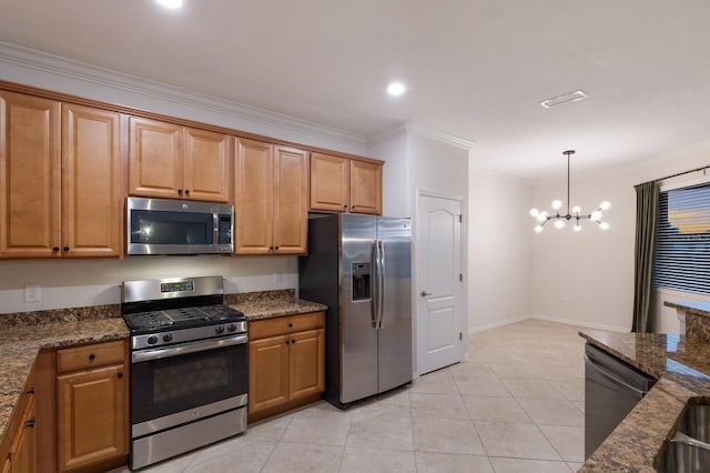 kitchen featuring dark stone counters, crown molding, appliances with stainless steel finishes, and a chandelier