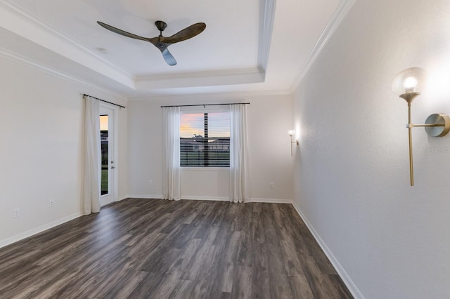 13627 American Prairie Pl, Lakewood Ranch, FL 34211 - empty room with a tray ceiling, dark wood-type flooring, ornamental molding, ceiling fan, and baseboards