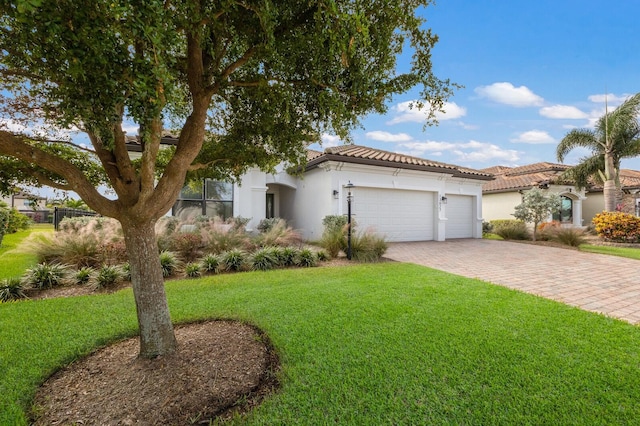 13627 American Prairie Pl, Lakewood Ranch, FL 34211 - view of front of house featuring decorative driveway, a garage, a front lawn, stucco siding, and a tile roof