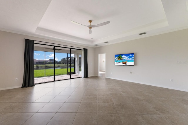 tiled empty room featuring a raised ceiling, ceiling fan, and crown molding