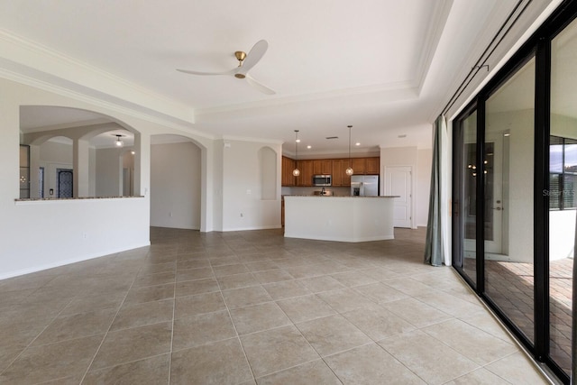 13627 American Prairie Pl, Lakewood Ranch, FL 34211 - unfurnished living room with light tile patterned flooring, a ceiling fan, crown molding, recessed lighting, and arched walkways