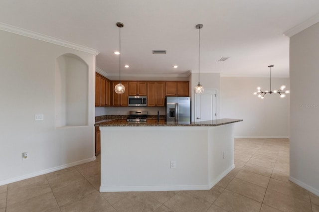 13627 American Prairie Pl, Lakewood Ranch, FL 34211 - kitchen with appliances with stainless steel finishes, brown cabinetry, baseboards, dark stone countertops, and crown molding