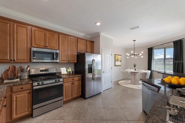 kitchen with hanging light fixtures, stainless steel appliances, a notable chandelier, light tile patterned floors, and ornamental molding