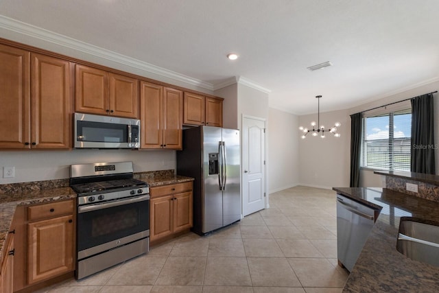 13627 American Prairie Pl, Lakewood Ranch, FL 34211 - kitchen featuring appliances with stainless steel finishes, crown molding, a chandelier, brown cabinets, and light tile patterned floors