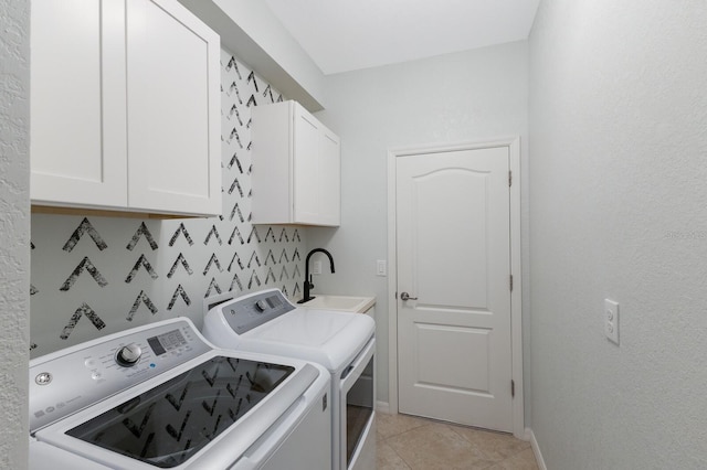 laundry room with cabinets, separate washer and dryer, light tile patterned flooring, and sink