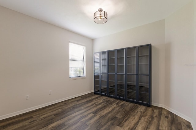 unfurnished room with dark hardwood / wood-style floors