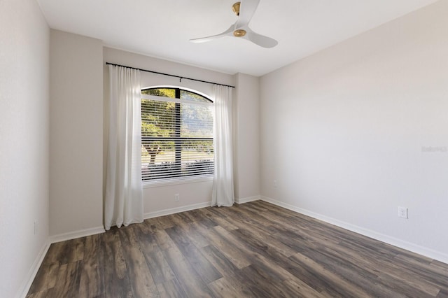 unfurnished room with ceiling fan and dark wood-type flooring