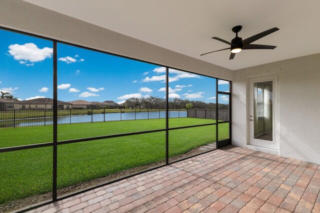 13627 American Prairie Pl, Lakewood Ranch, FL 34211 - unfurnished sunroom with a water view, a ceiling fan, and a residential view