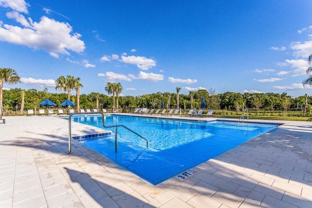 13627 American Prairie Pl, Lakewood Ranch, FL 34211 - community pool featuring a patio and view of scattered trees