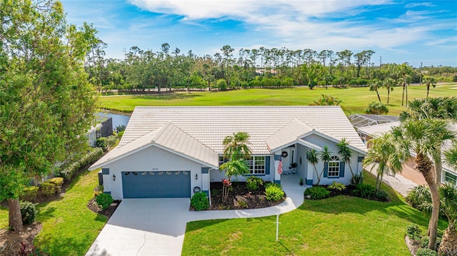 view of front of home with a front yard and a garage