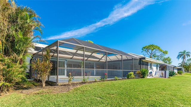 back of property featuring a lanai and a yard