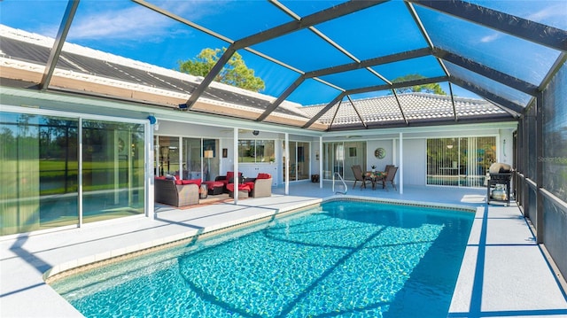 view of swimming pool featuring area for grilling, an outdoor hangout area, glass enclosure, and a patio area