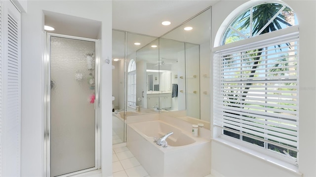 bathroom with tile patterned flooring and independent shower and bath