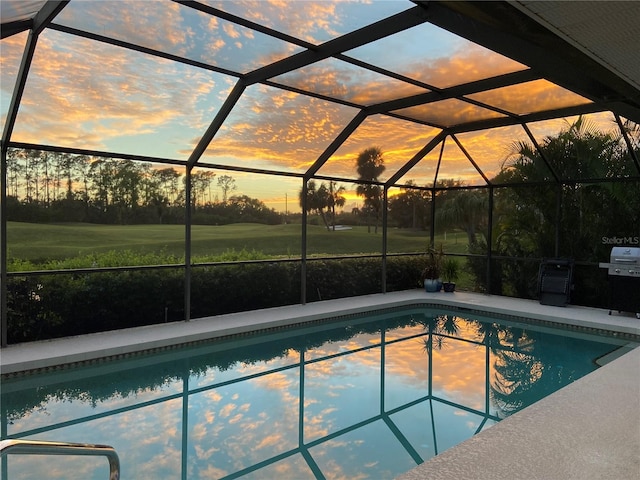 pool at dusk with a grill