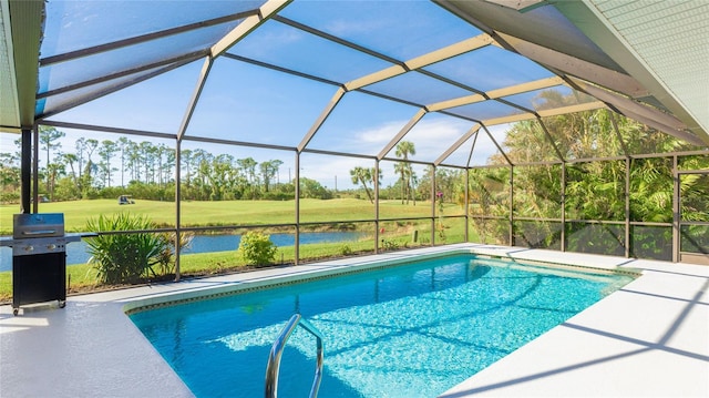 view of swimming pool featuring a lawn, glass enclosure, area for grilling, and a water view